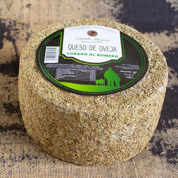Queso entero con su corteza cubierta totalmente de romero. En su base superior presenta una etiqueta con los datos del queso.