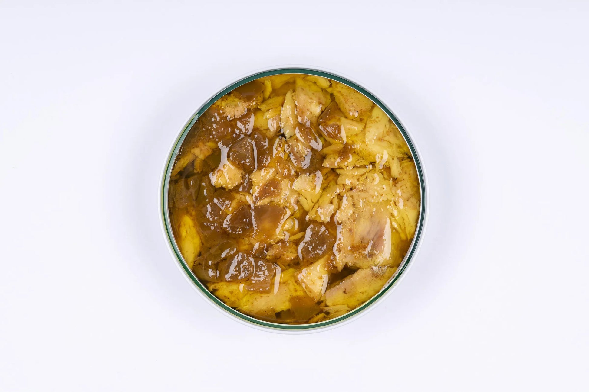 Se muestra una lata de atún al curry desde arriba y sin tapa, de modo que se ve todo el contenido en su salsa.
