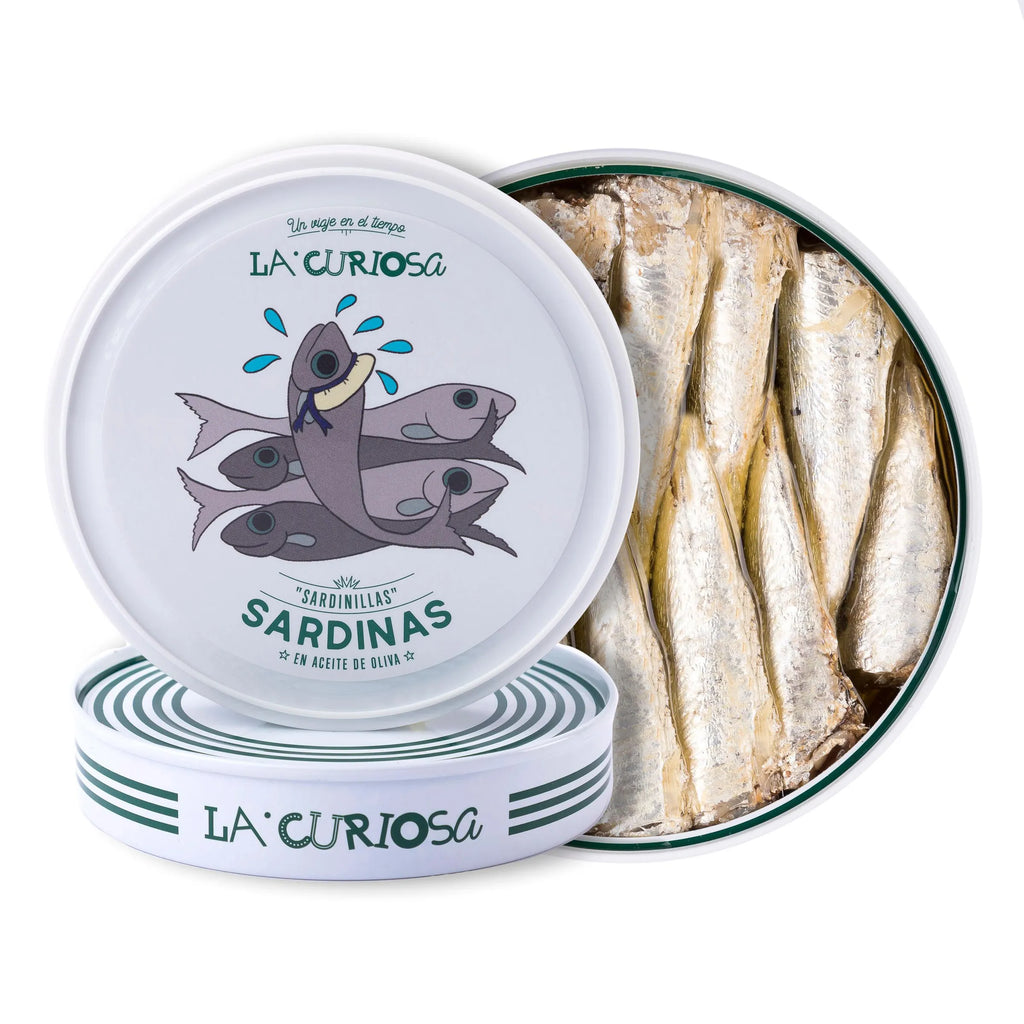 Se muestra una lata de sardinillas muy apetecible. La lata está abierta y se aprecian varias sardinillas.